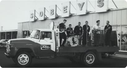 An Image of musican and singer giving singing performance on truck