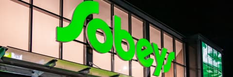 A lit Sobeys logo outside a building