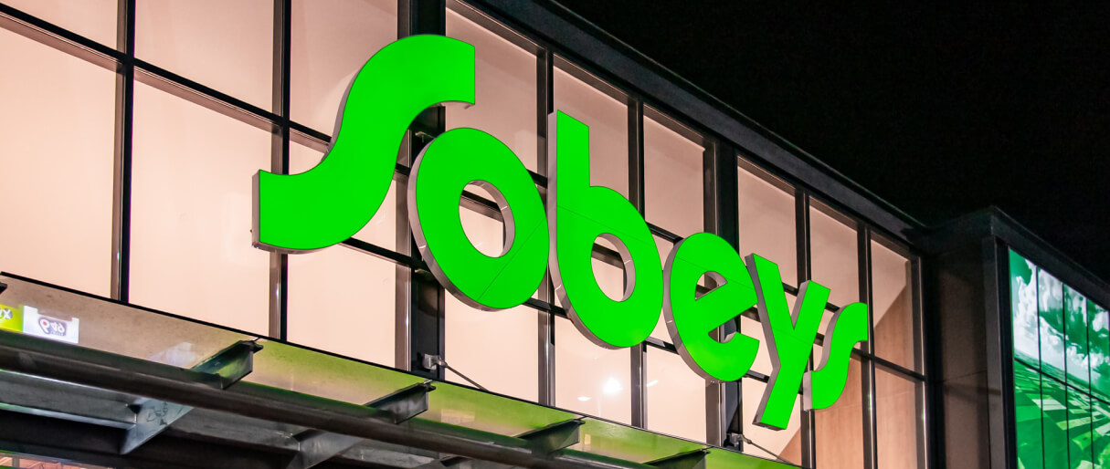 A lit Sobeys logo outside a building